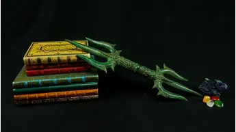 Trishula Vajra vert posé sur des livres
